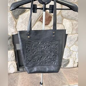 Hand tooled leather tote
Alejandro Yeo